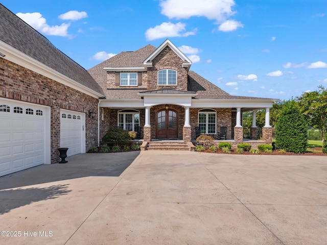 view of front of house with brick siding, an attached garage, concrete driveway, and roof with shingles