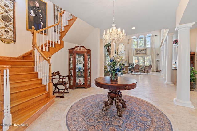 entrance foyer featuring ornate columns, stairway, a chandelier, and recessed lighting