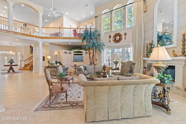 building lobby featuring a towering ceiling, stairway, and recessed lighting