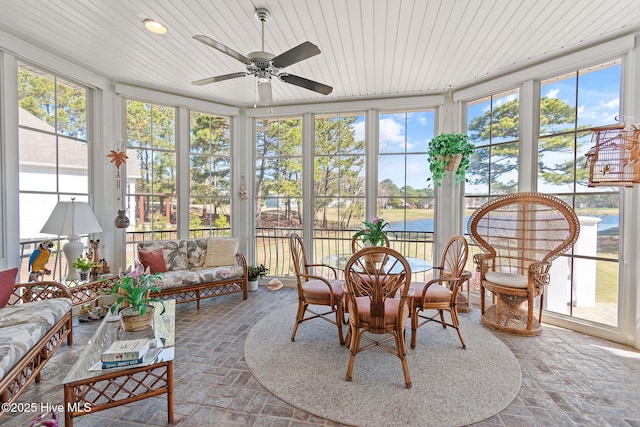 sunroom with wood ceiling, plenty of natural light, and brick flooring