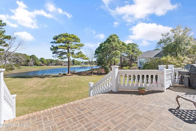 view of patio featuring a water view and grilling area