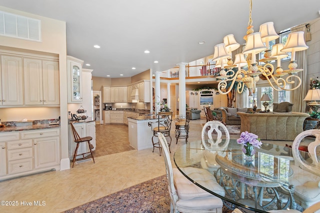 dining space with recessed lighting, a chandelier, and light tile patterned floors