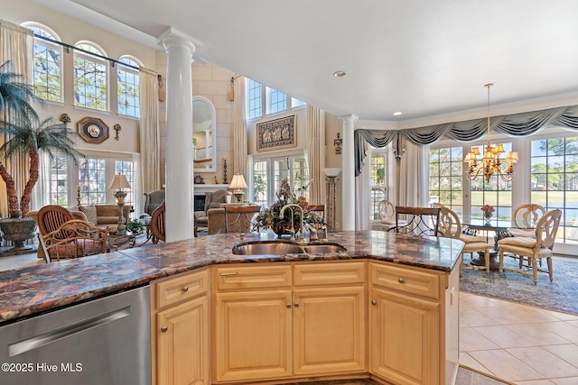 kitchen featuring a sink, stainless steel dishwasher, open floor plan, healthy amount of natural light, and recessed lighting