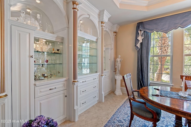 dining space featuring healthy amount of natural light and ornamental molding