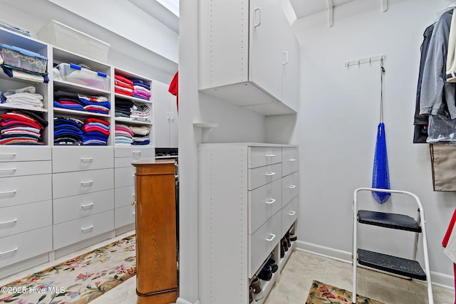 walk in closet featuring light tile patterned flooring