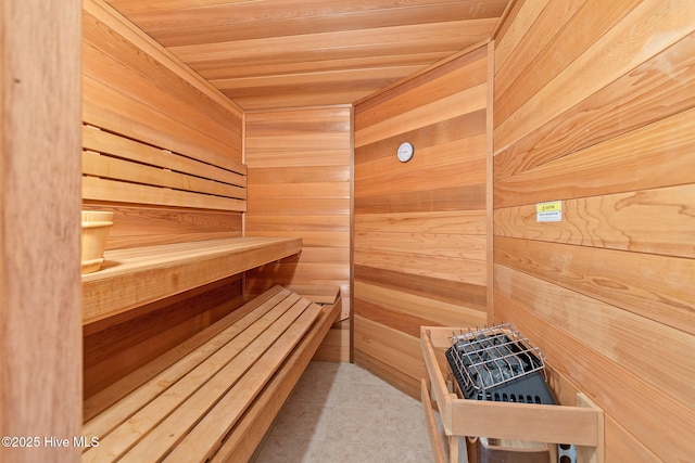 sauna / steam room featuring wooden walls, wooden ceiling, and tile patterned flooring