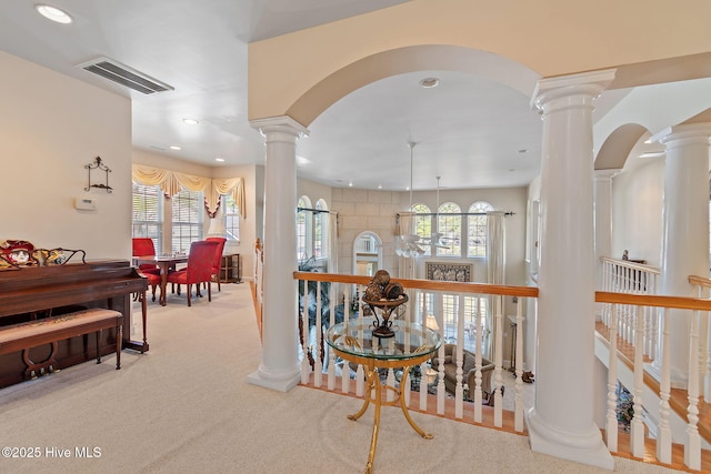 hallway with ornate columns, carpet flooring, recessed lighting, and arched walkways