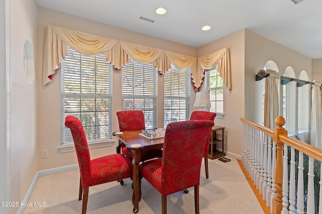carpeted dining space featuring plenty of natural light, baseboards, and recessed lighting