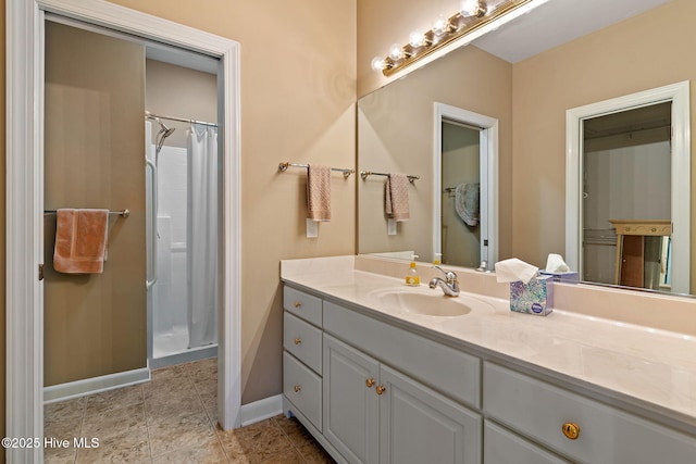 bathroom with vanity, a shower with curtain, and baseboards