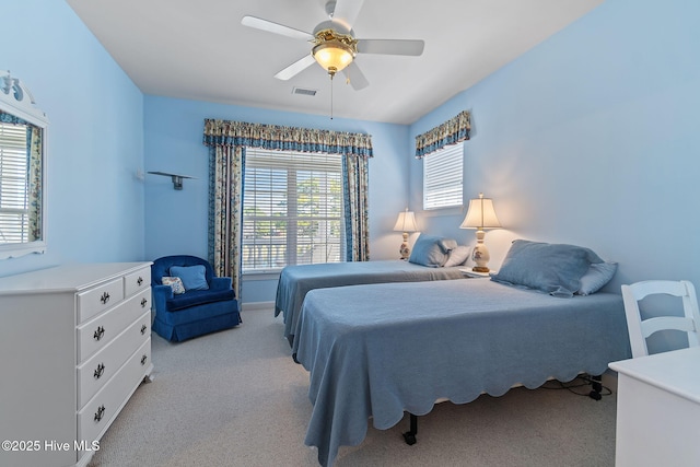 bedroom featuring light carpet and ceiling fan