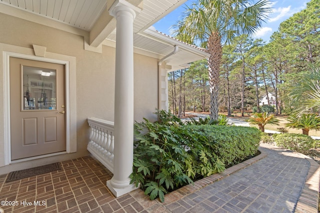 entrance to property with stucco siding