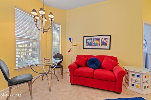 living room with a chandelier and baseboards