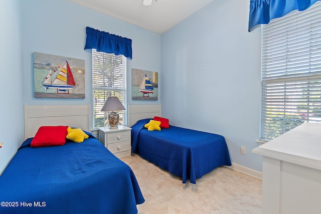 bedroom featuring tile patterned floors and baseboards