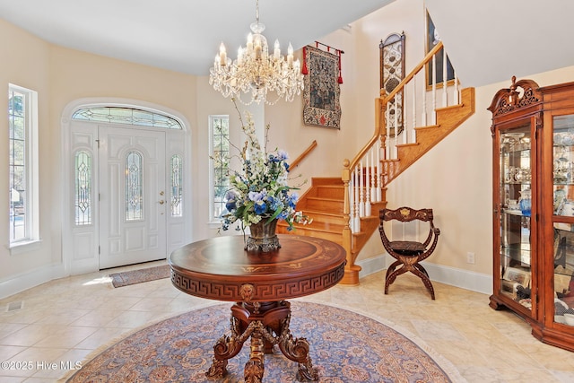 2760 Marsh Point Ln SE, Southport, NC 28461 - entryway featuring a chandelier, stairway, baseboards, and tile patterned floors