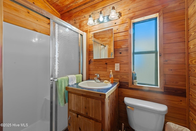 bathroom featuring vanity, a shower stall, toilet, and wood walls