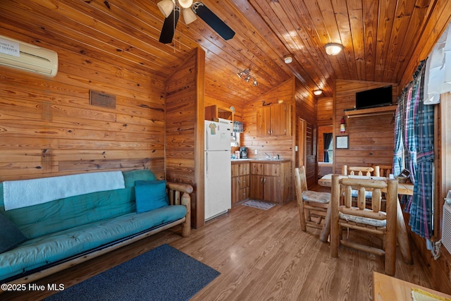 living room featuring wood walls, an AC wall unit, lofted ceiling, light wood-style flooring, and wooden ceiling