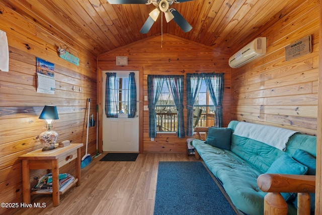 living area with wooden walls, ceiling fan, wooden ceiling, and a wall mounted AC