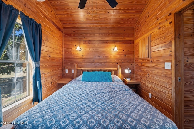 bedroom featuring wooden walls, wooden ceiling, a ceiling fan, and vaulted ceiling