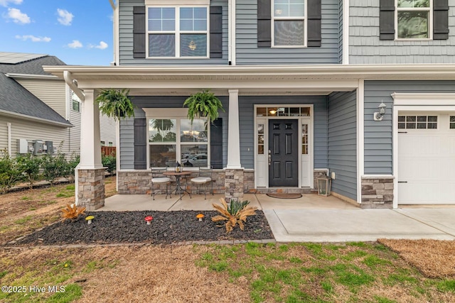 property entrance featuring stone siding and a porch