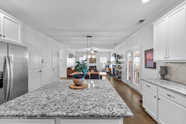 kitchen featuring visible vents, white cabinets, stainless steel fridge with ice dispenser, ornamental molding, and dark wood-type flooring