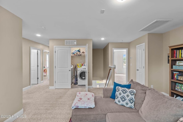 carpeted living room with recessed lighting, baseboards, visible vents, and washing machine and clothes dryer