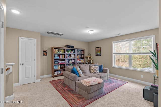 living area featuring carpet, visible vents, and baseboards