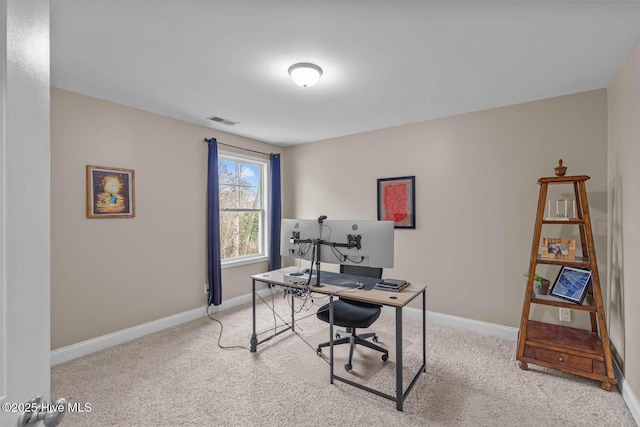 carpeted office space with baseboards and visible vents