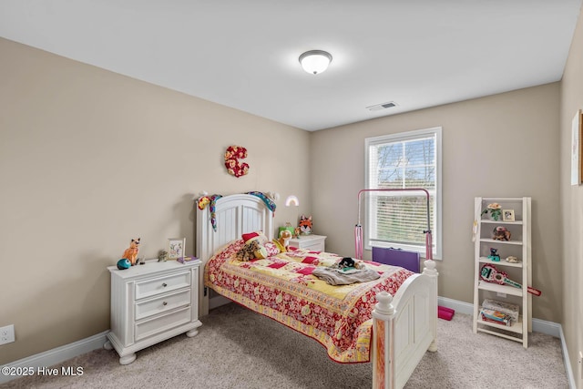 bedroom with baseboards, visible vents, and light colored carpet