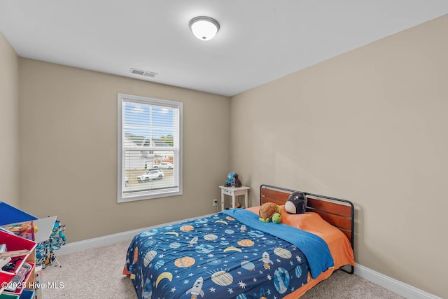 bedroom with baseboards, visible vents, and carpet flooring