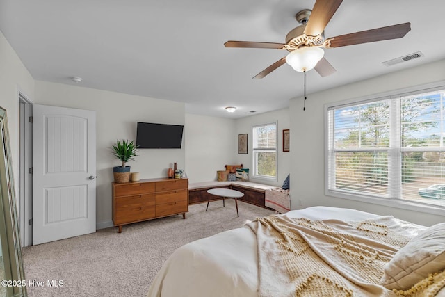 bedroom featuring visible vents, ceiling fan, and light carpet