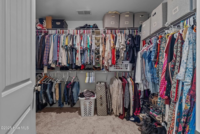 walk in closet featuring carpet floors and visible vents