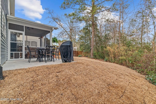 view of yard featuring a sunroom, a patio, and fence