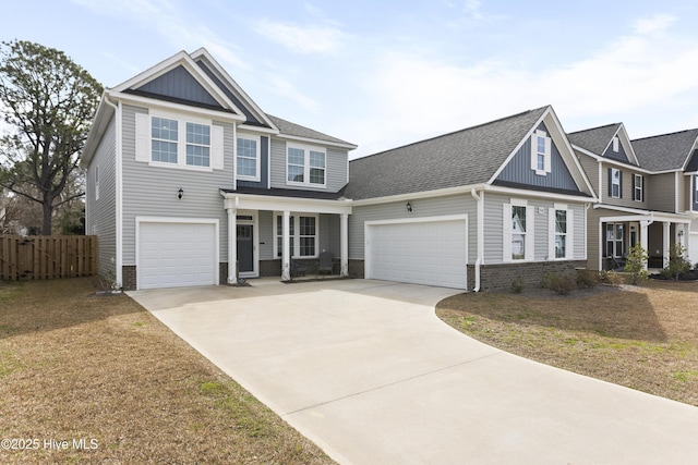 view of front of property with brick siding, a shingled roof, board and batten siding, fence, and driveway