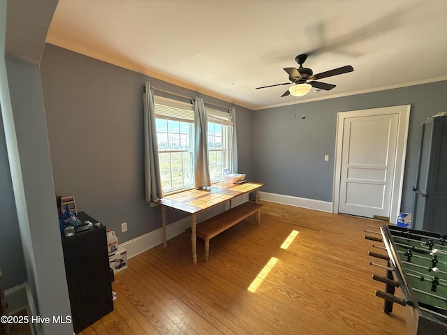 office space featuring ceiling fan, ornamental molding, light wood-style flooring, and baseboards