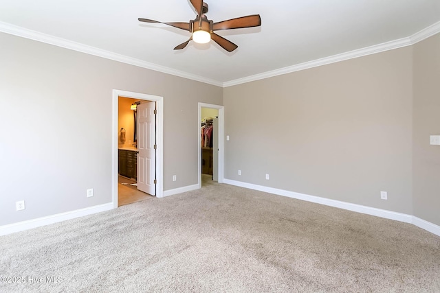 empty room with ceiling fan, ornamental molding, light colored carpet, and baseboards