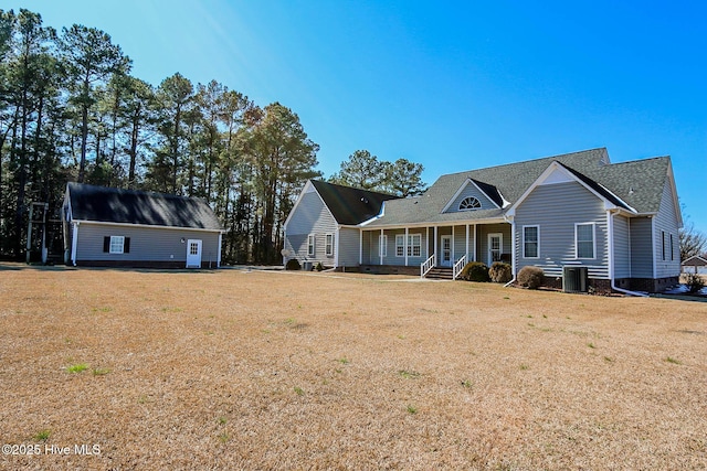 view of front of property featuring covered porch, central AC unit, and a front lawn