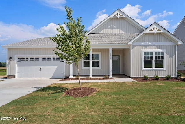 4506 Fairhaven Dr W, Wilson, NC 27893 - view of front of property with a shingled roof, an attached garage, concrete driveway, a front yard, and a porch