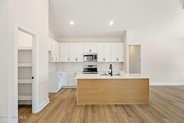 4506 Fairhaven Dr W, Wilson, NC 27893 - kitchen featuring stainless steel appliances, a center island with sink, tasteful backsplash, white cabinets, and recessed lighting