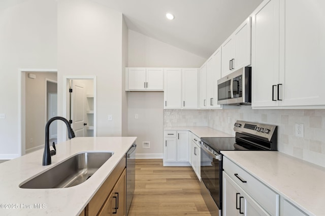 4506 Fairhaven Dr W, Wilson, NC 27893 - kitchen with stainless steel appliances, light stone countertops, white cabinetry, decorative backsplash, and recessed lighting
