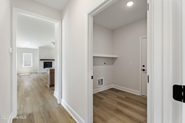 4506 Fairhaven Dr W, Wilson, NC 27893 - laundry room featuring light wood finished floors, hookup for an electric dryer, and a fireplace