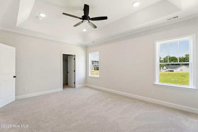 4506 Fairhaven Dr W, Wilson, NC 27893 - unfurnished bedroom featuring a raised ceiling, light colored carpet, recessed lighting, a spacious closet, and a ceiling fan