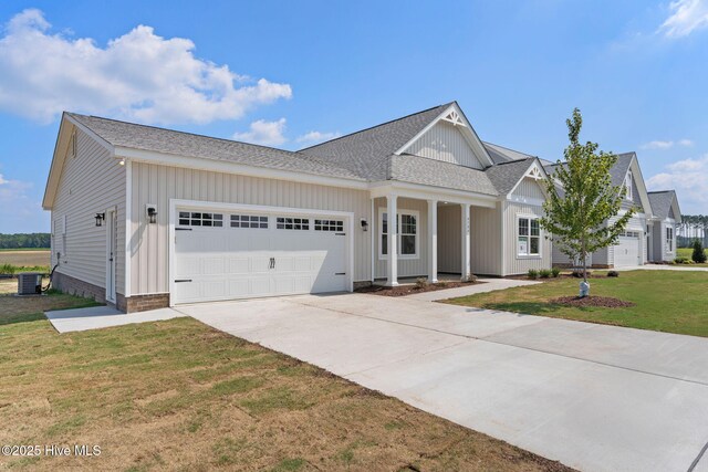 4506 Fairhaven Dr W, Wilson, NC 27893 - modern inspired farmhouse with a garage, concrete driveway, a front yard, a shingled roof, and board and batten siding