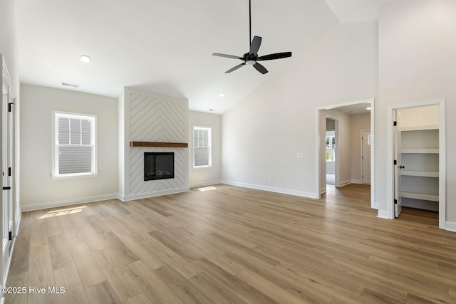 4506 Fairhaven Dr W, Wilson, NC 27893 - unfurnished living room featuring a ceiling fan, light wood-type flooring, high vaulted ceiling, a large fireplace, and recessed lighting
