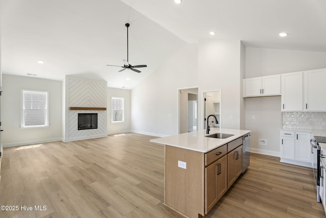 4506 Fairhaven Dr W, Wilson, NC 27893 - kitchen featuring stainless steel dishwasher, a ceiling fan, light wood-style floors, an island with sink, and white cabinetry