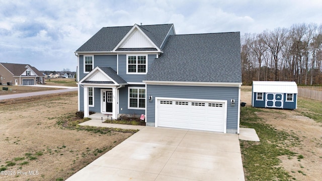 traditional-style house with a storage unit, a shingled roof, concrete driveway, an attached garage, and an outdoor structure