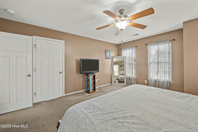 bedroom featuring visible vents, carpet floors, a ceiling fan, and baseboards