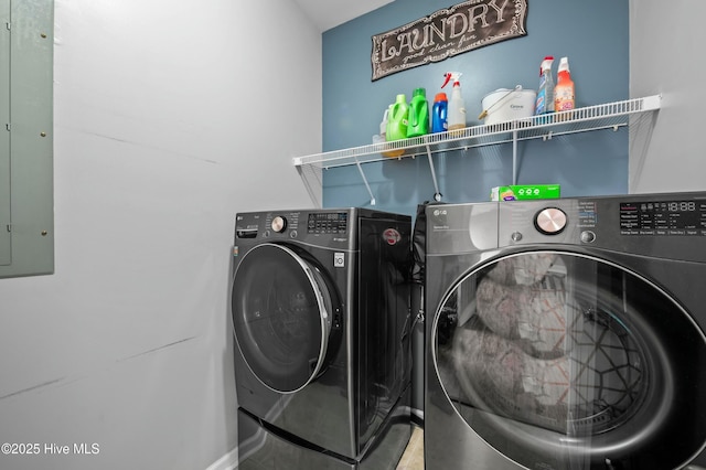 laundry area with laundry area, washing machine and dryer, and electric panel