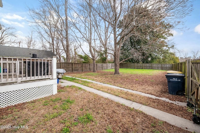 view of yard featuring a deck and a fenced backyard