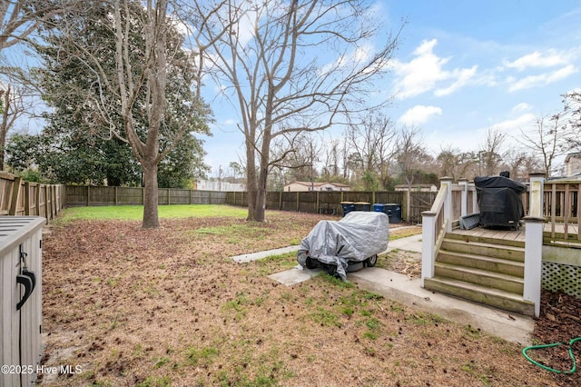 view of yard with a fenced backyard and a wooden deck