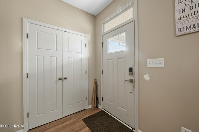 doorway to outside featuring wood finished floors and baseboards